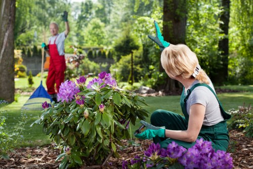 Volunteers sorting garden waste at a community recycling point